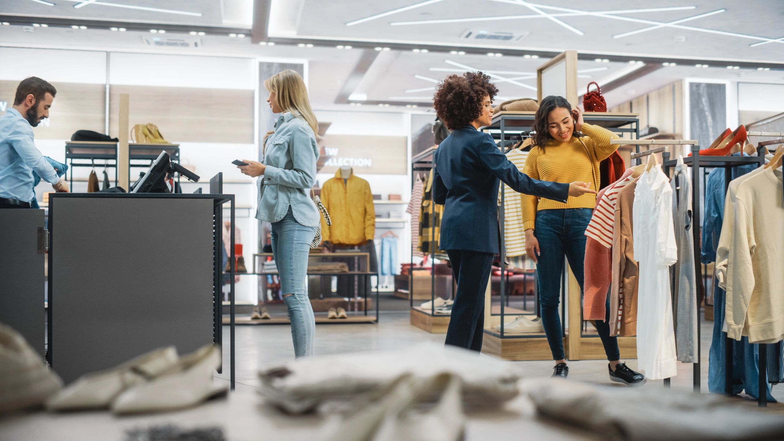 Women shopping for dresses in a modern fashion boutique