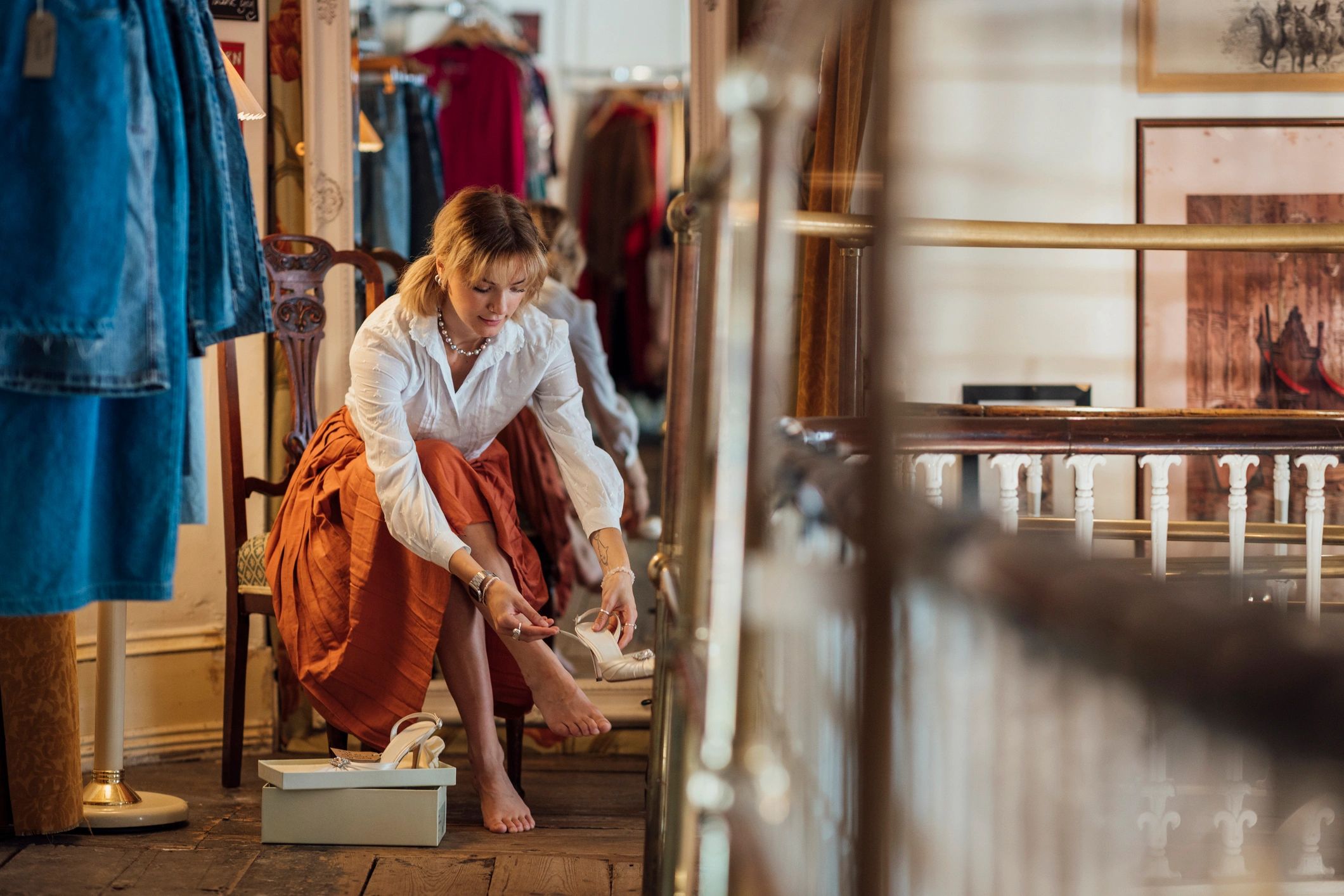 Woman trying on shoes while shopping in a boutique