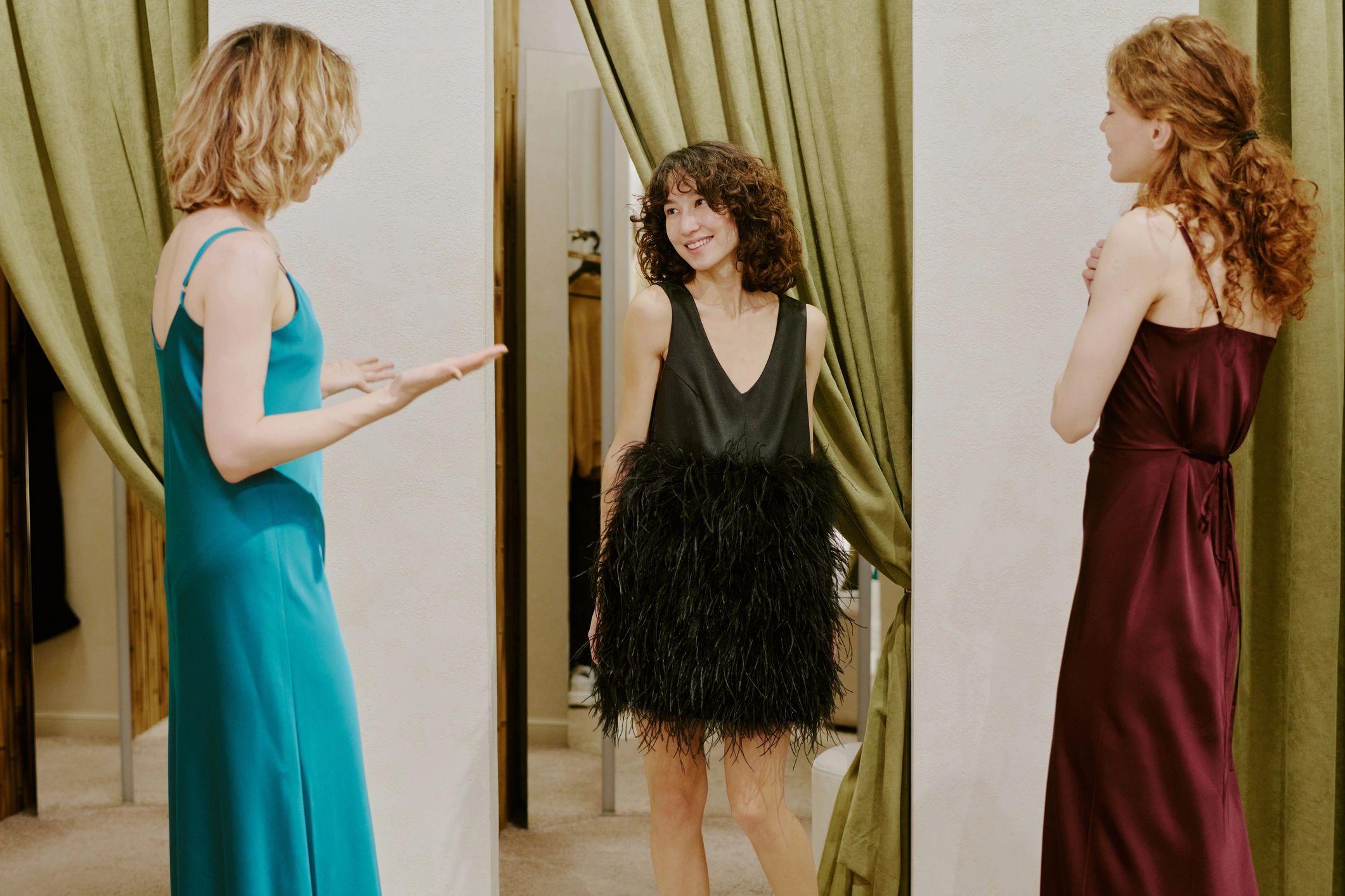 Friends trying on dresses together in a boutique